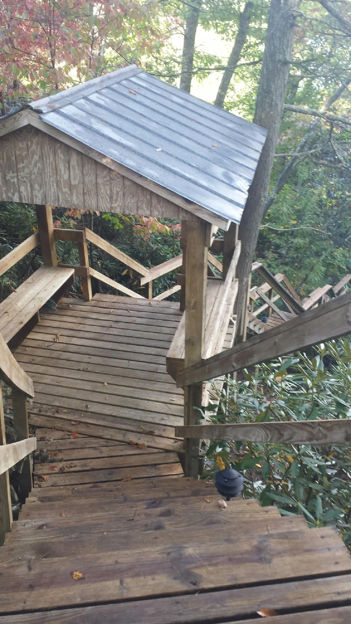 Metal roofed shelter over wooden steps on a wooded walkway — Skylight Repair & Installation work by our crew in West Stockbridge